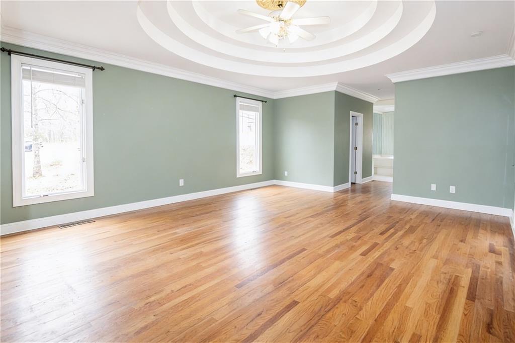 10060 Buice Road Alpharetta, GA 30022 - Photo 53 of 75 a view of an empty room with wooden floor and a window