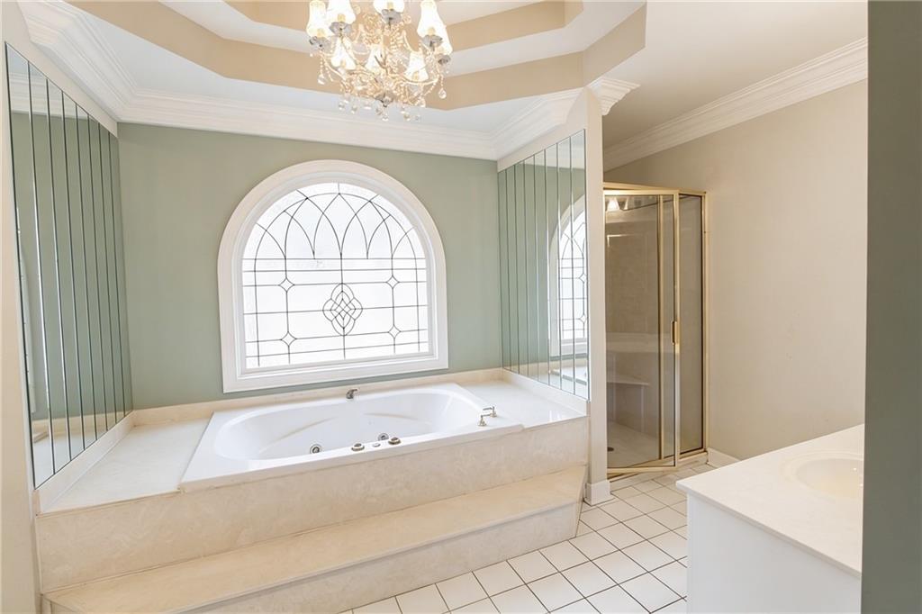 10060 Buice Road Alpharetta, GA 30022 - Photo 59 of 75 a spacious bathroom with a bathtub and a shower