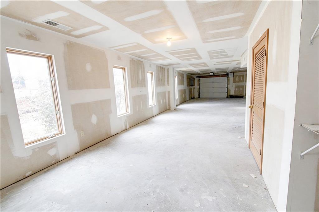 10060 Buice Road Alpharetta, GA 30022 - Photo 68 of 75 a view of livingroom with an empty space and windows