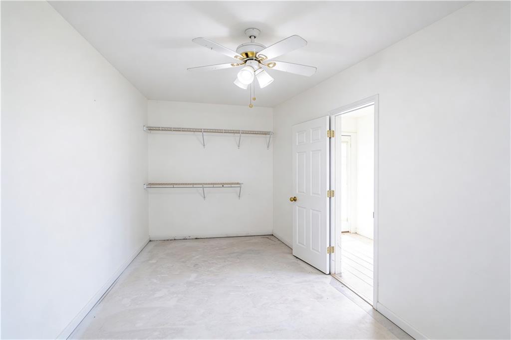10060 Buice Road Alpharetta, GA 30022 - Photo 69 of 75 an empty room with a chandelier fan and windows