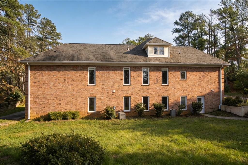 10060 Buice Road Alpharetta, GA 30022 - Photo 8 of 75 front view of house with a yard