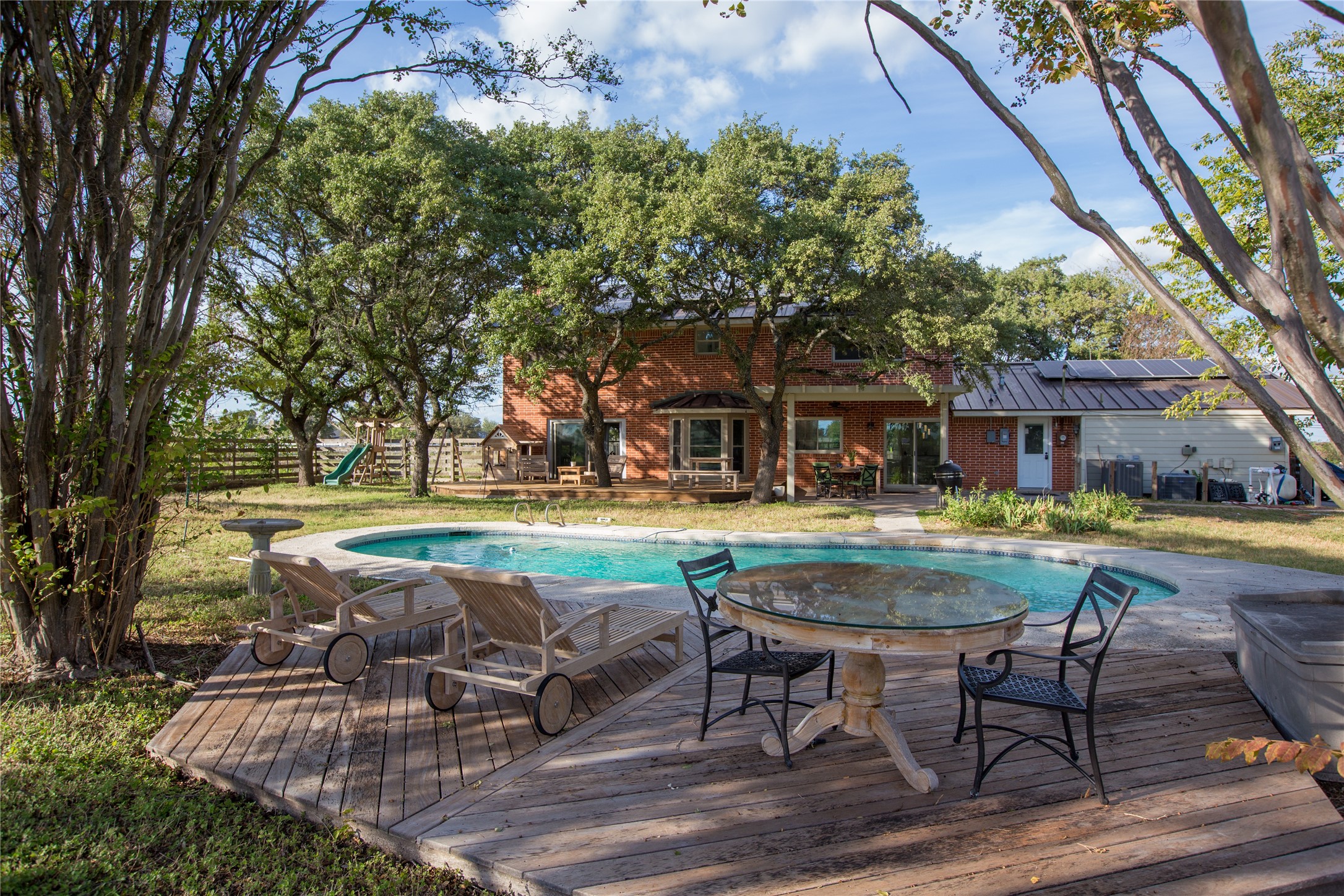 3517 Gattis School Road Round Rock, TX 78664 - Photo 10 of 16 A private backyard oasis features a glistening pool and generous wooden deck, perfect for sun-drenched leisure.