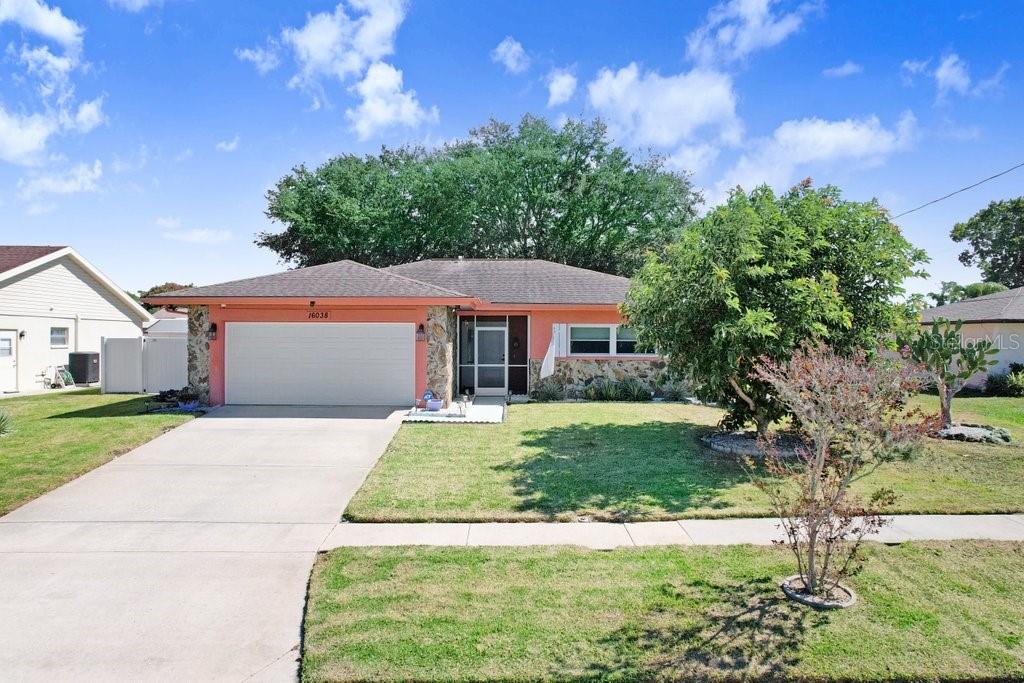 16038 Tree Line Drive Hudson, FL 34667 - Photo 1 of 1 a front view of a house with a yard