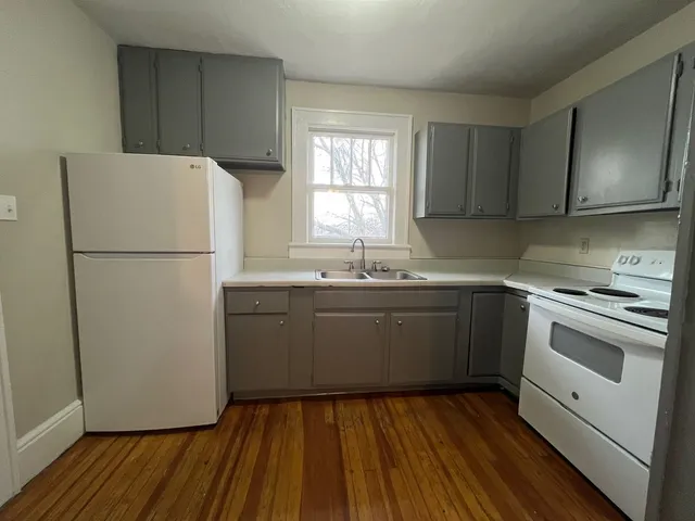 a kitchen with a sink a refrigerator and window