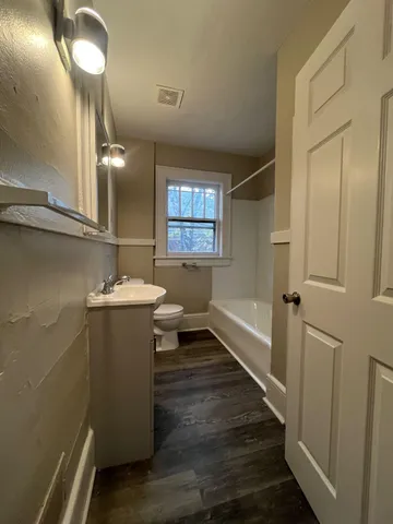 a bathroom with sink shower and mirror