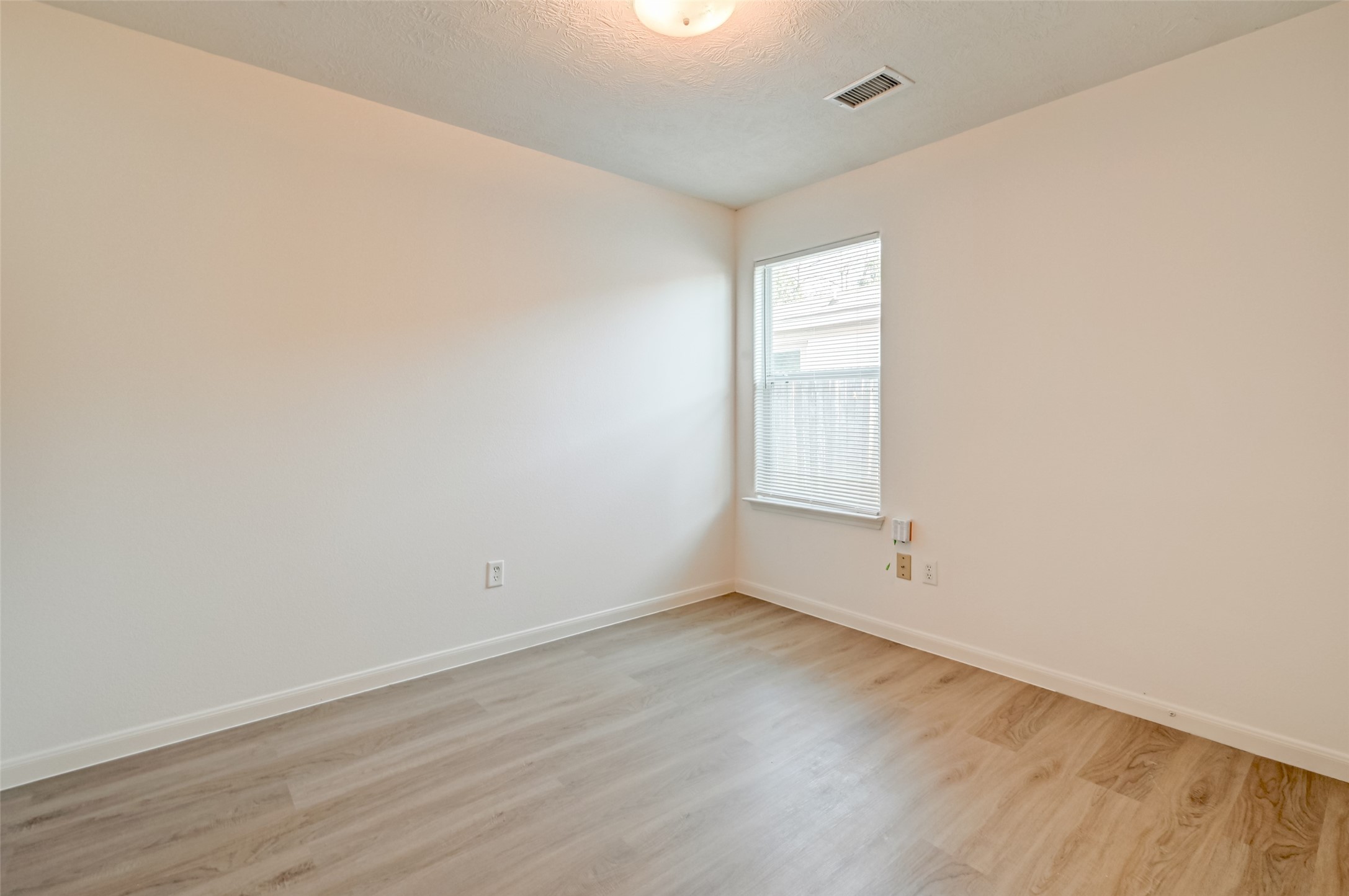 4830 Comal River Loop Spring, TX 77386 - Photo 22 of 43 an empty room with wooden floor and windows