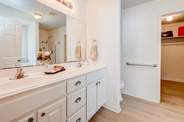 a bathroom with a double vanity sink and mirror