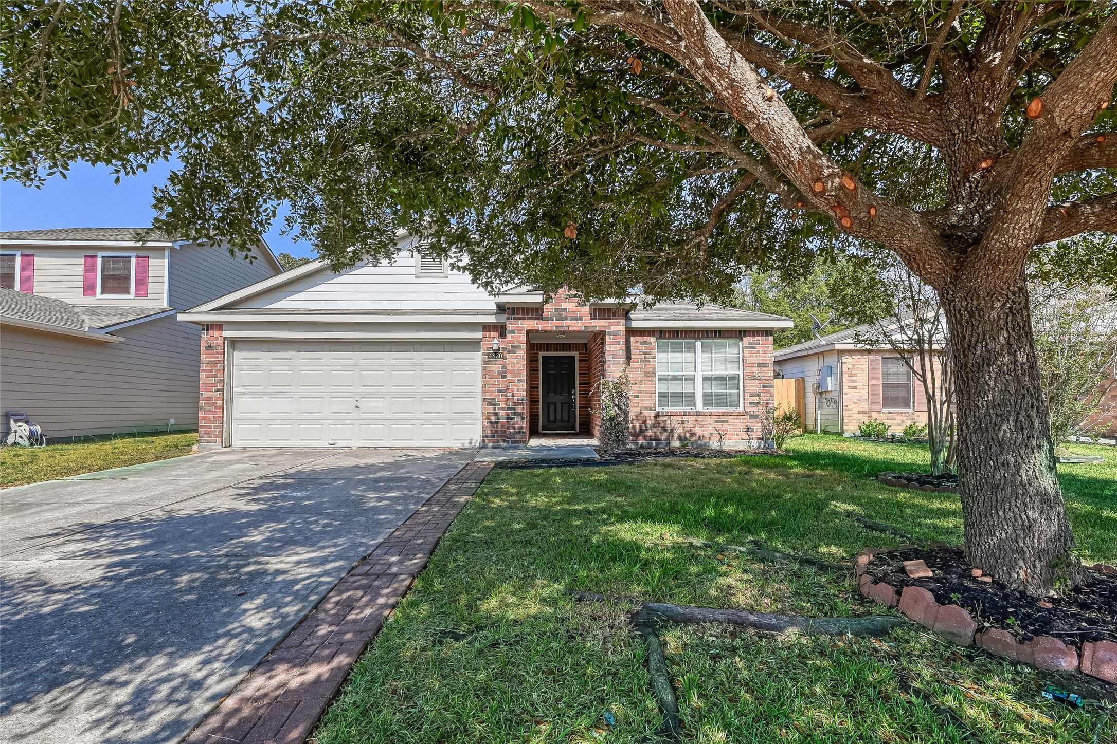 4830 Comal River Loop Spring, TX 77386 - Photo 4 of 43 a front view of a house with a garden and yard