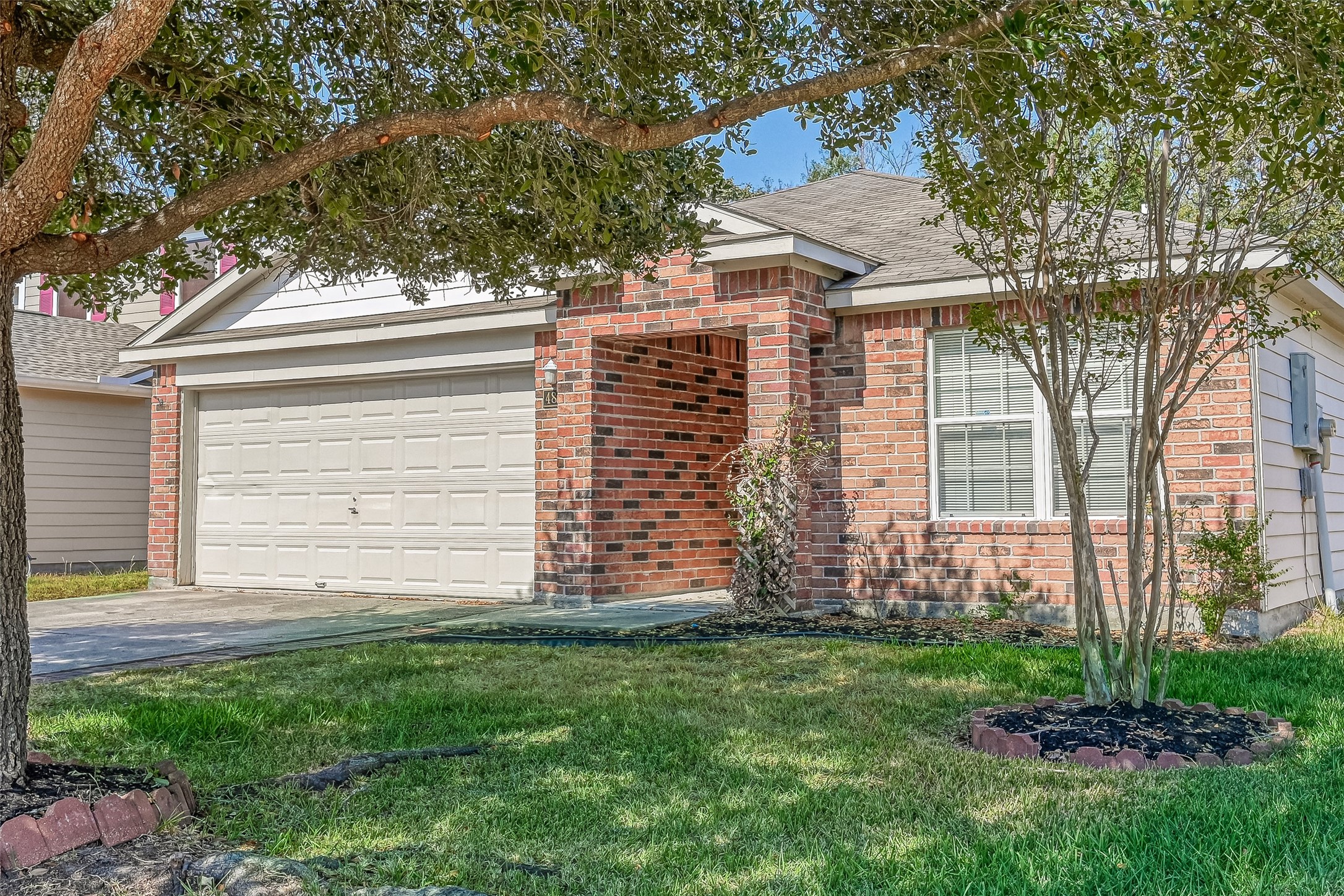4830 Comal River Loop Spring, TX 77386 - Photo 7 of 43 a view of a house with a small yard and a large tree