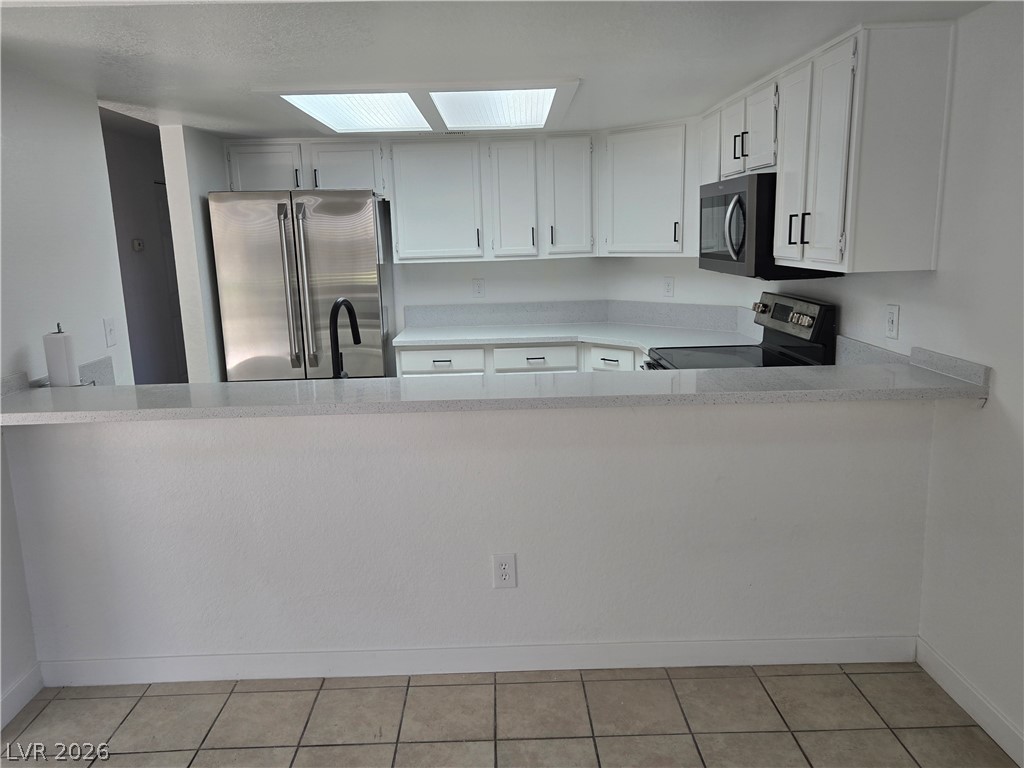 6250 West Flamingo Road, Unit 131 Las Vegas, NV 89103 - Photo 6 of 11 A well-equipped kitchen boasts gleaming stainless steel appliances and abundant counter space.