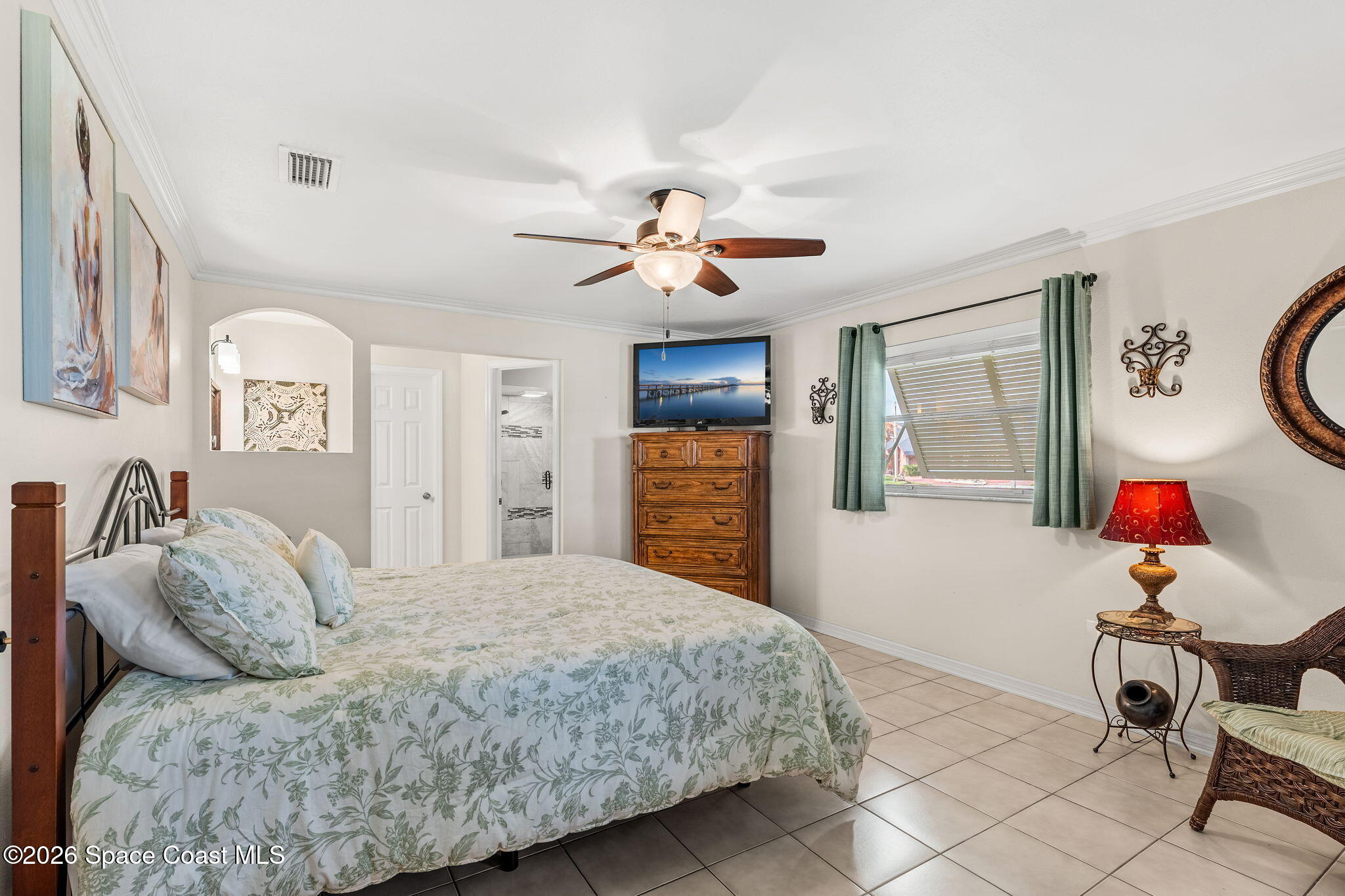 31 Fairway Drive Cocoa Beach, FL 32931 - Photo 13 of 53 a bedroom with a bed and a chandelier