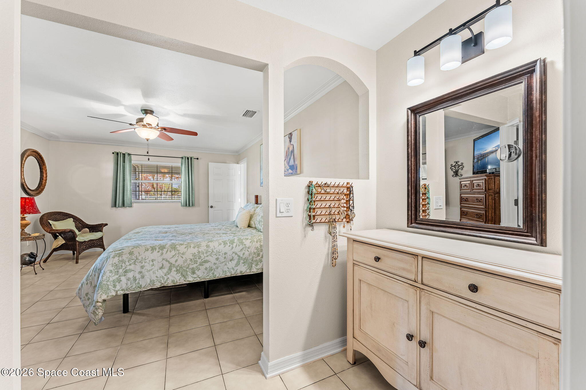 31 Fairway Drive Cocoa Beach, FL 32931 - Photo 14 of 53 a bedroom with a bed and a chandelier
