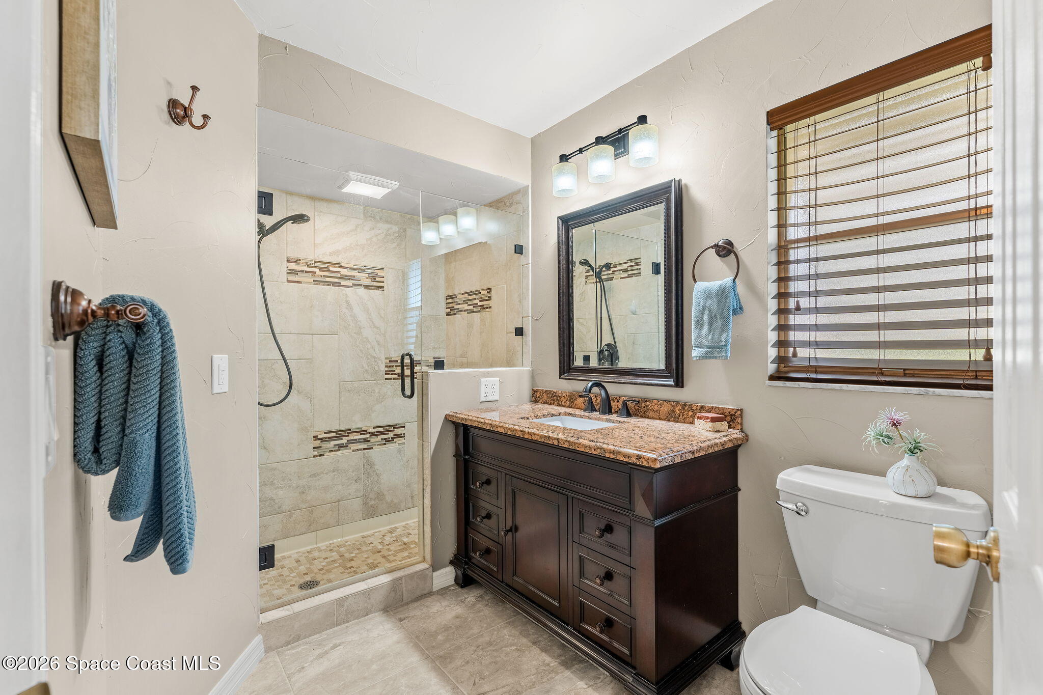 31 Fairway Drive Cocoa Beach, FL 32931 - Photo 16 of 53 a bathroom with a toilet sink vanity granite and shower