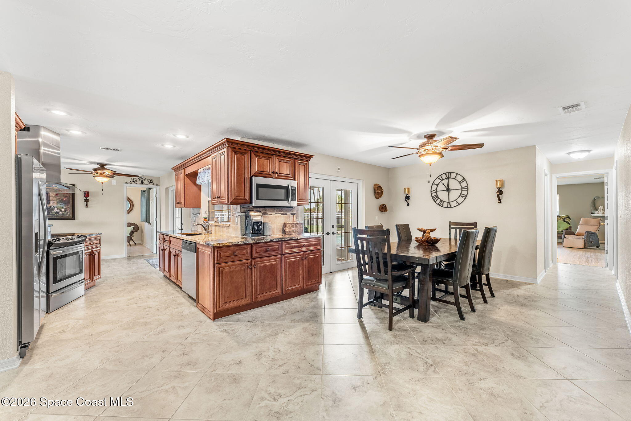 31 Fairway Drive Cocoa Beach, FL 32931 - Photo 18 of 53 a large kitchen with a table and chairs