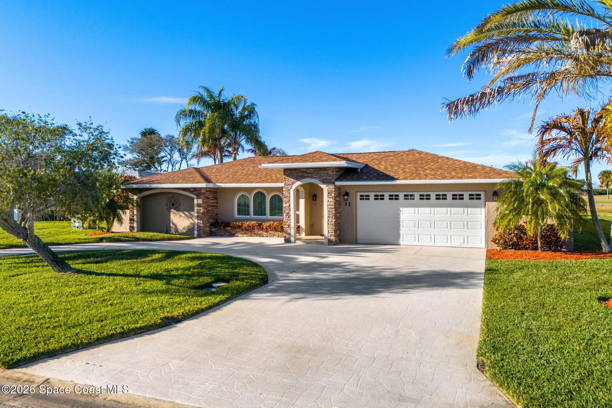 31 Fairway Drive Cocoa Beach, FL 32931 - Photo 2 of 53 a front view of a house with swimming pool having outdoor seating