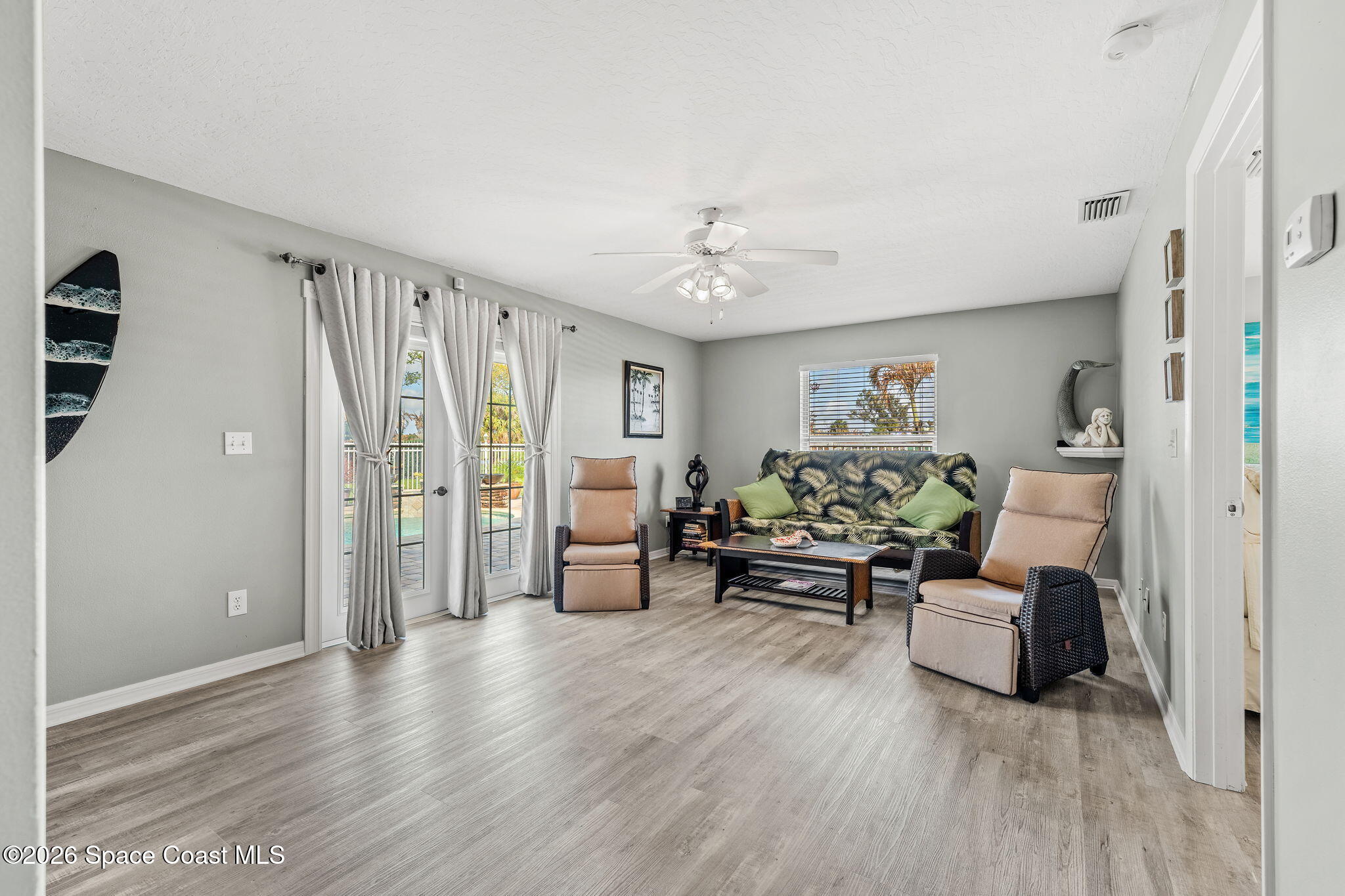 31 Fairway Drive Cocoa Beach, FL 32931 - Photo 25 of 53 a living room with furniture and a chandelier