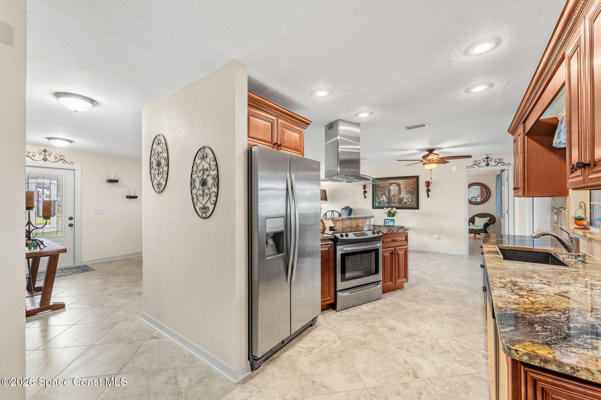 31 Fairway Drive Cocoa Beach, FL 32931 - Photo 3 of 53 a kitchen with stainless steel appliances granite countertop a refrigerator and a stove