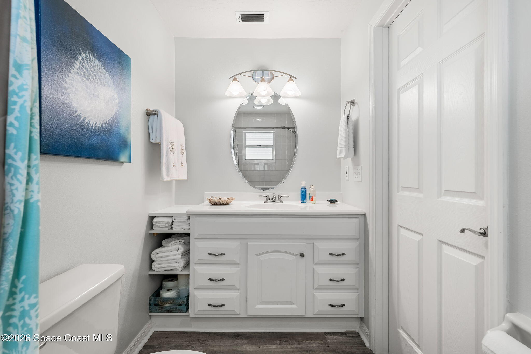31 Fairway Drive Cocoa Beach, FL 32931 - Photo 31 of 53 a bathroom with a sink a toilet and a mirror