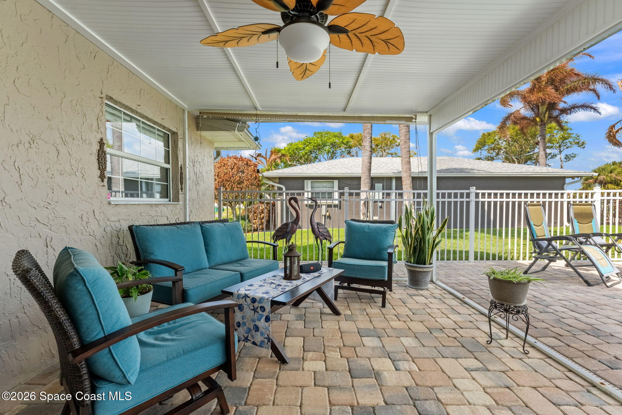 31 Fairway Drive Cocoa Beach, FL 32931 - Photo 35 of 53 a view of a patio with a dining table and chairs
