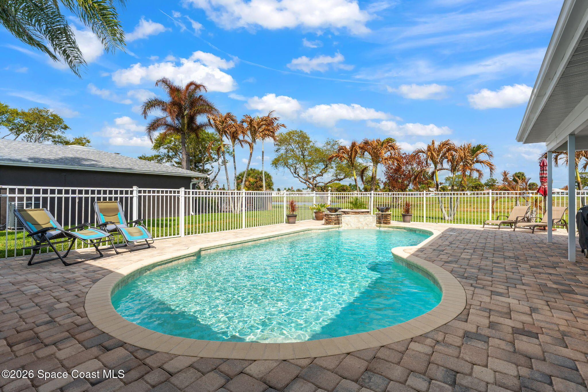 31 Fairway Drive Cocoa Beach, FL 32931 - Photo 40 of 53 a view of a swimming pool with a lounge chair