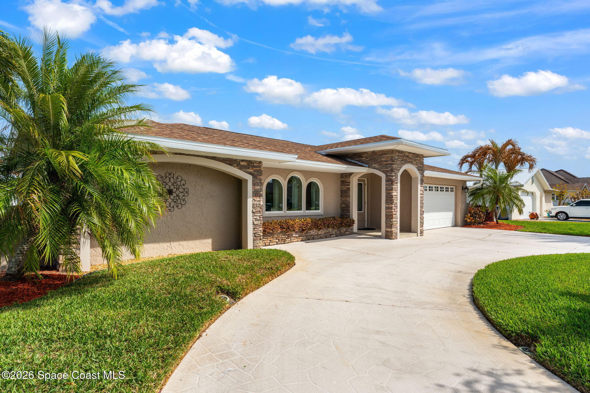 31 Fairway Drive Cocoa Beach, FL 32931 - Photo 49 of 53 a front view of a house with a garden
