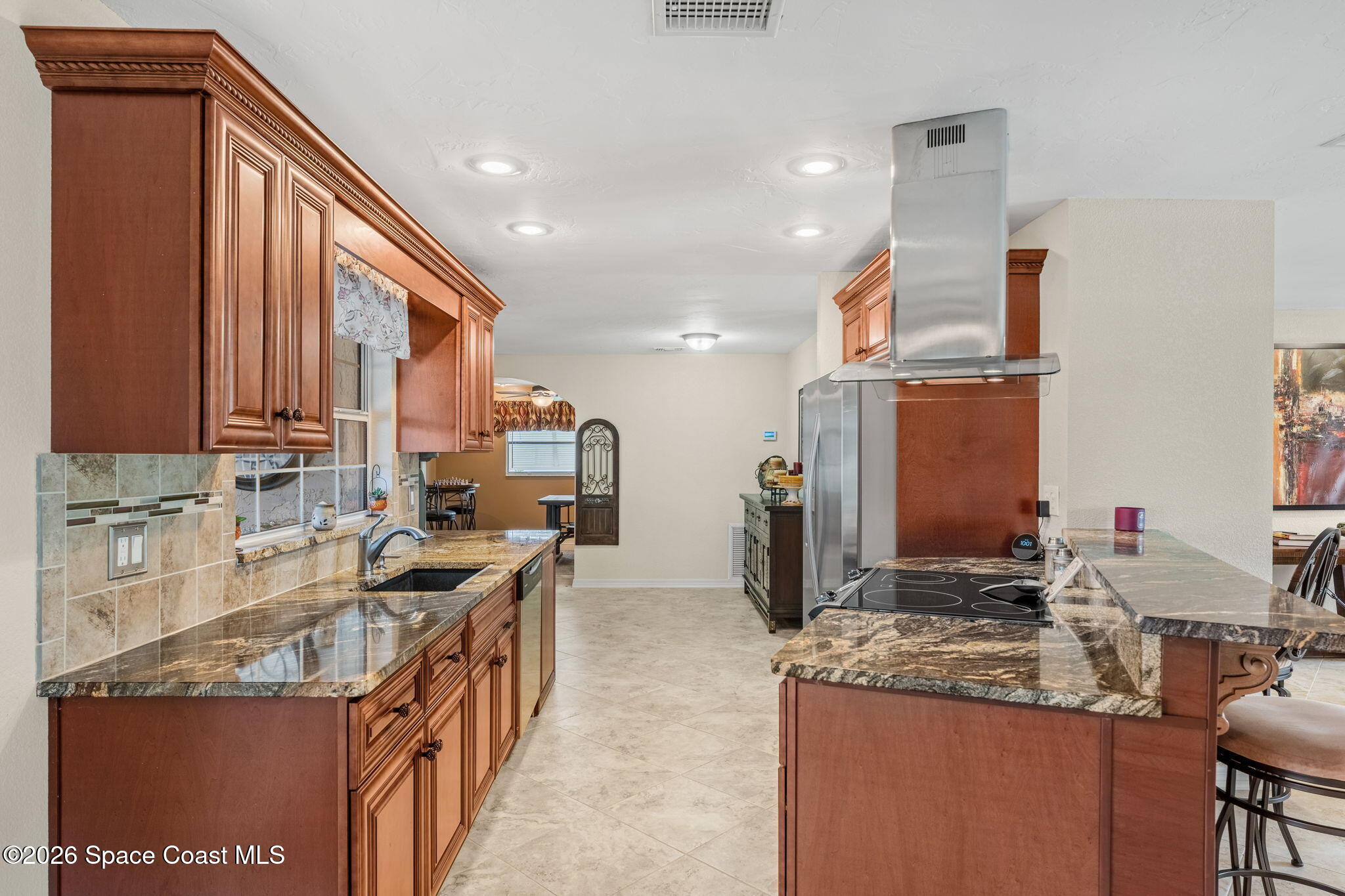 31 Fairway Drive Cocoa Beach, FL 32931 - Photo 6 of 53 a kitchen with stainless steel appliances granite countertop a sink stove and cabinets