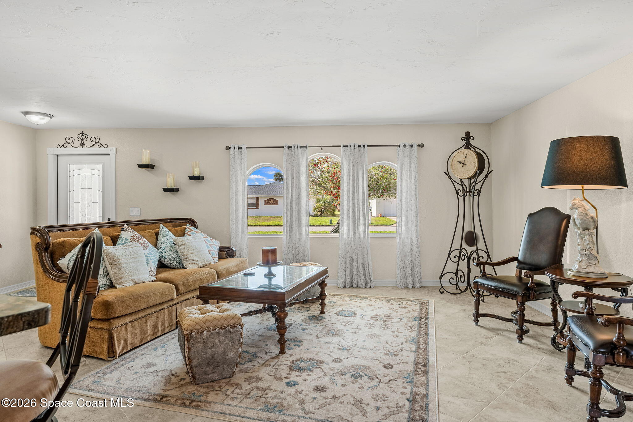 31 Fairway Drive Cocoa Beach, FL 32931 - Photo 8 of 53 a living room with furniture a rug and a window