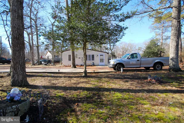a backyard of a house with lots of green space and fountain