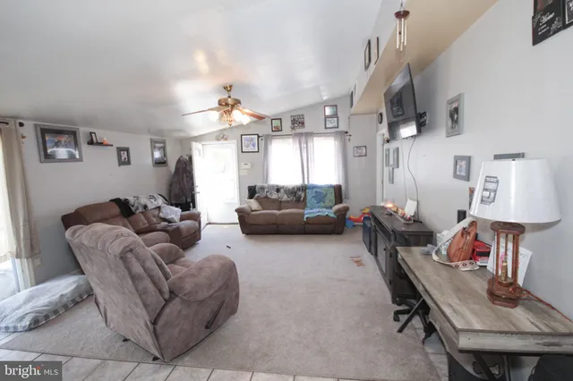 a living room with furniture a rug and a chandelier