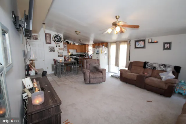 a living room with furniture a chandelier and a window