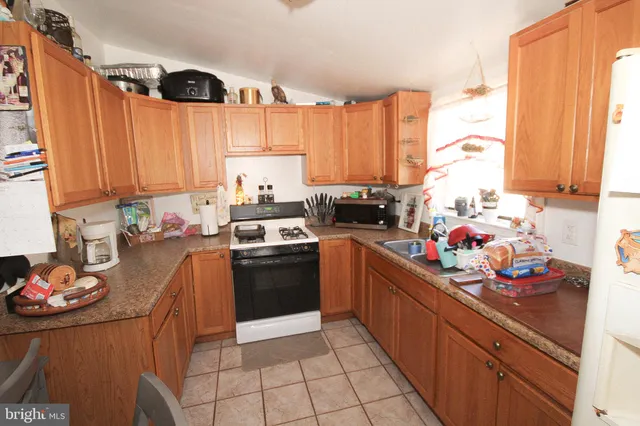 a kitchen with stainless steel appliances a stove sink and cabinets