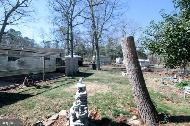 a backyard of a house with barbeque oven and outdoor seating