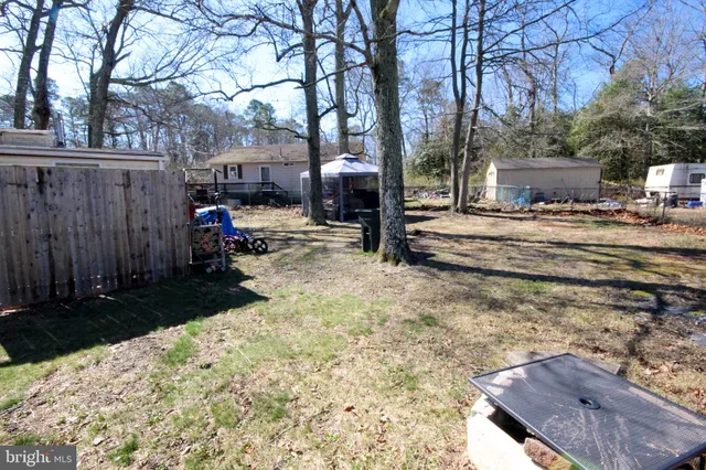 a view of a back yard of the house with a car park