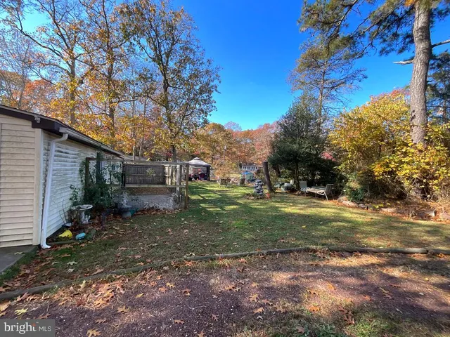 a backyard of a house with outdoor seating and trees