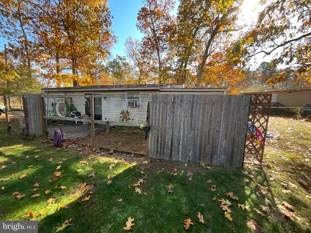 a backyard of a house with yard and outdoor seating