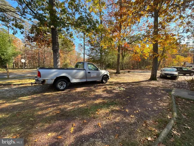 a car parked in front of a house with a yard