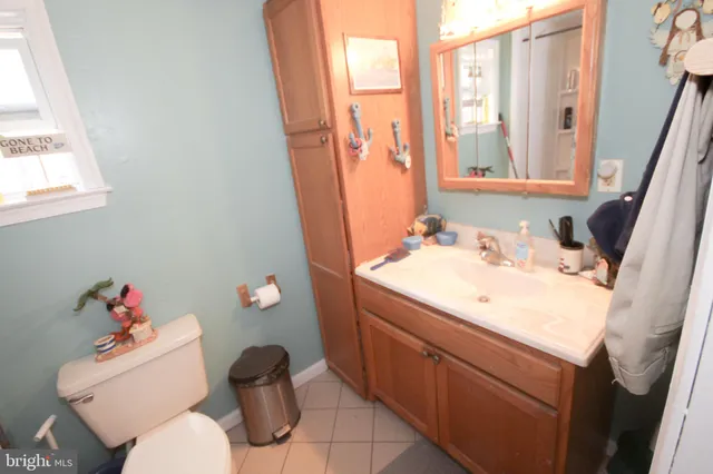 a bathroom with a sink vanity mirror and toilet