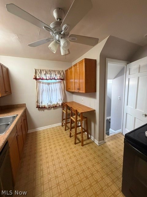 1388 Cranover Road Lyndhurst, OH 44124 - Photo 15 of 35 Kitchen featuring wood-finish cabinetry, patterned vinyl flooring, a built-in breakfast bar, and a ceiling fan with integrated lighting