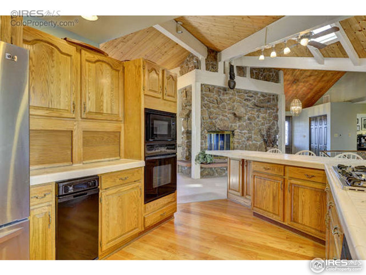 1755 View Point Road Boulder, CO 80305 - Photo 29 of 40 a kitchen with stainless steel appliances granite countertop a stove and a wooden cabinets