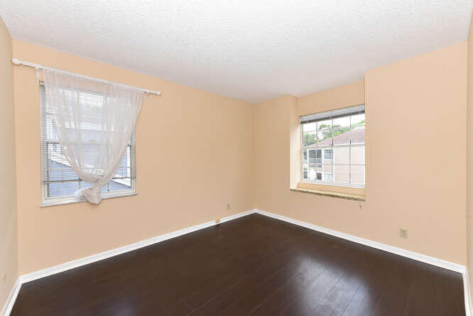 5359 Buckhead Circle Boca Raton, FL 33431 - Photo 14 of 27 an empty room with wooden floor and windows