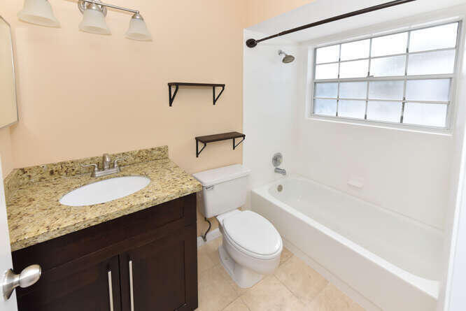 5359 Buckhead Circle Boca Raton, FL 33431 - Photo 15 of 27 a bathroom with a granite countertop sink toilet and shower