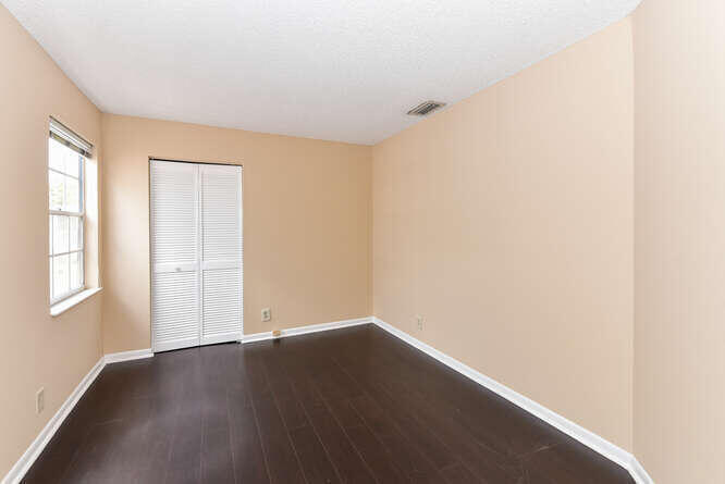 5359 Buckhead Circle Boca Raton, FL 33431 - Photo 16 of 27 an empty room with wooden floor and windows