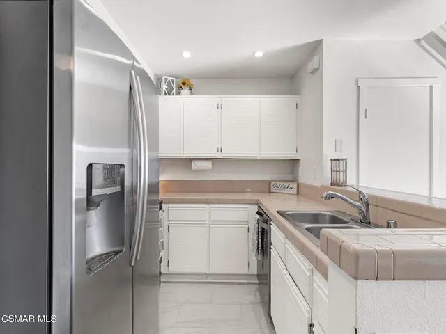 a kitchen with a sink appliances and cabinets