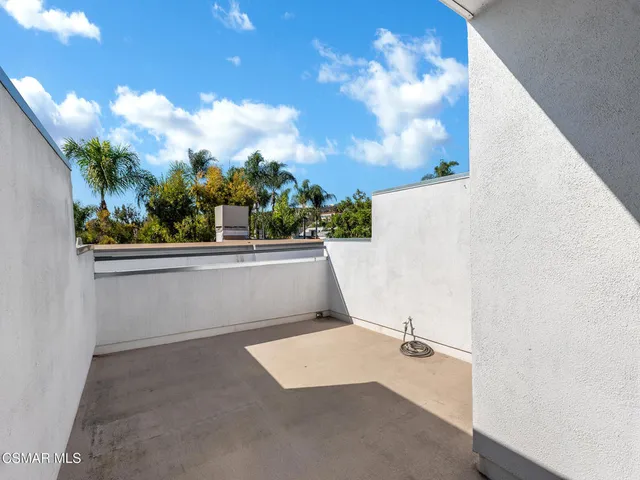 a view of balcony with wooden floor
