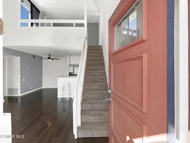 a view of entryway with wooden floor and stairs