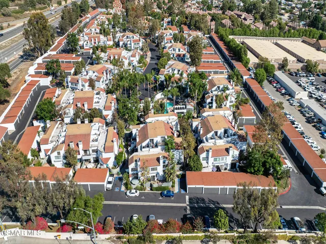 an aerial view of a house with garden space and swimming pool