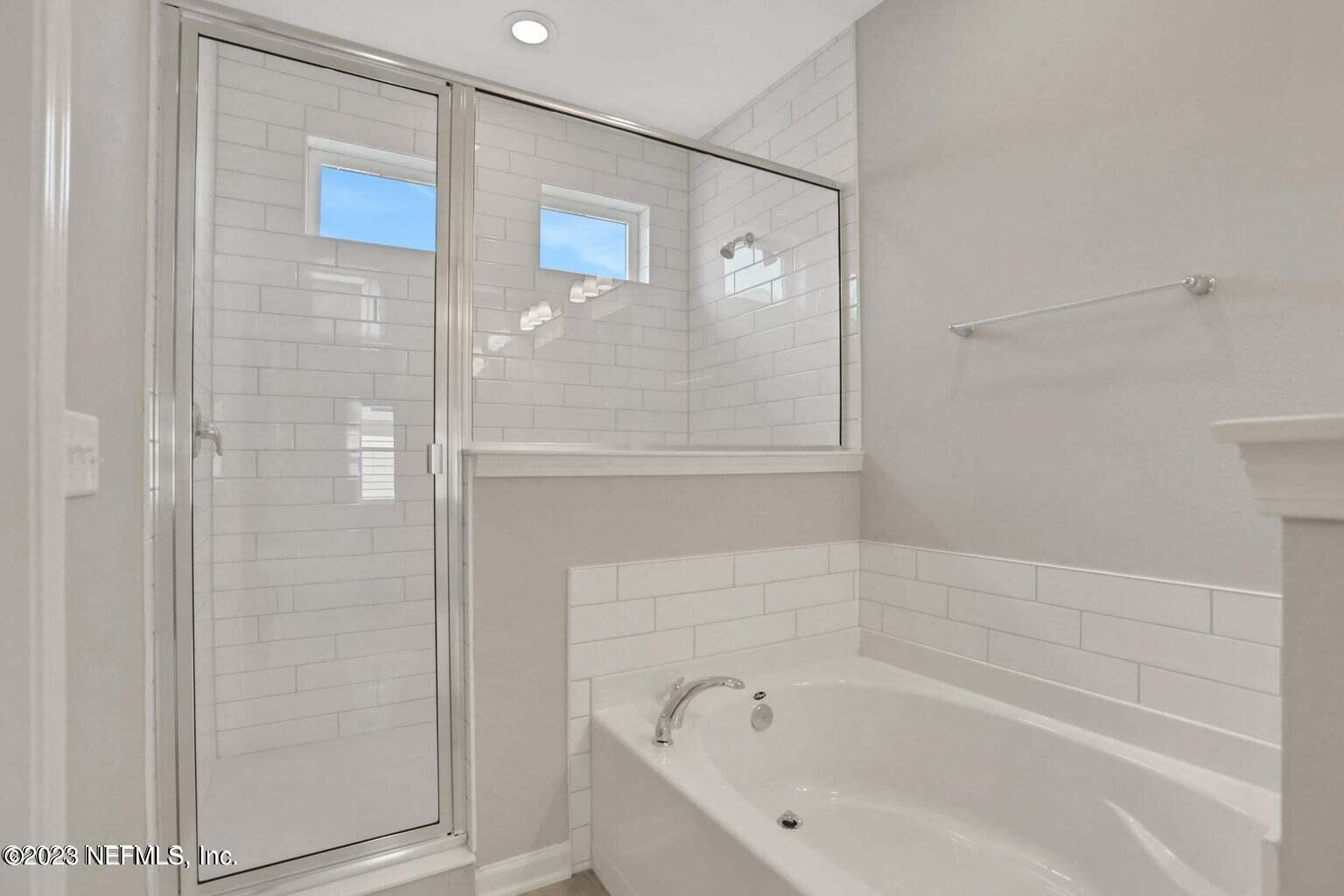 65 Torres Trace Street St. Augustine, FL 32095 - Photo 17 of 32 a bathroom with a bathtub and a shower