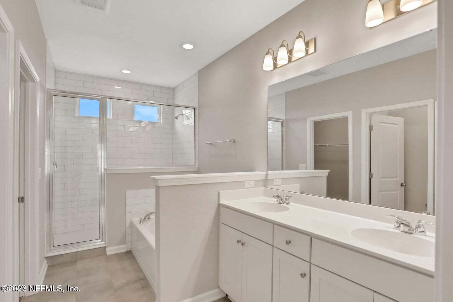 65 Torres Trace Street St. Augustine, FL 32095 - Photo 18 of 32 a bathroom with a sink double vanity and a mirror