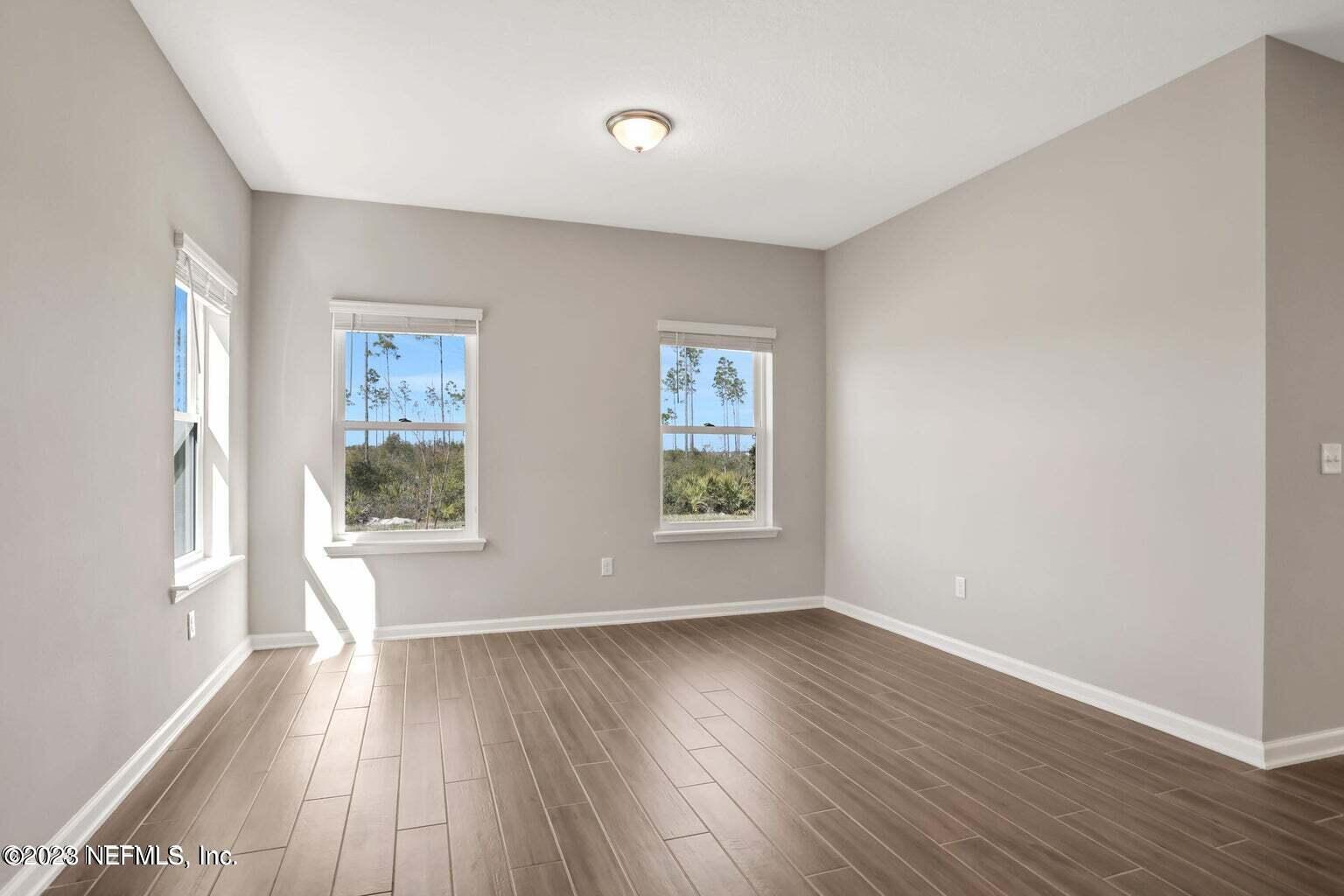 65 Torres Trace Street St. Augustine, FL 32095 - Photo 20 of 32 an empty room with wooden floor and windows
