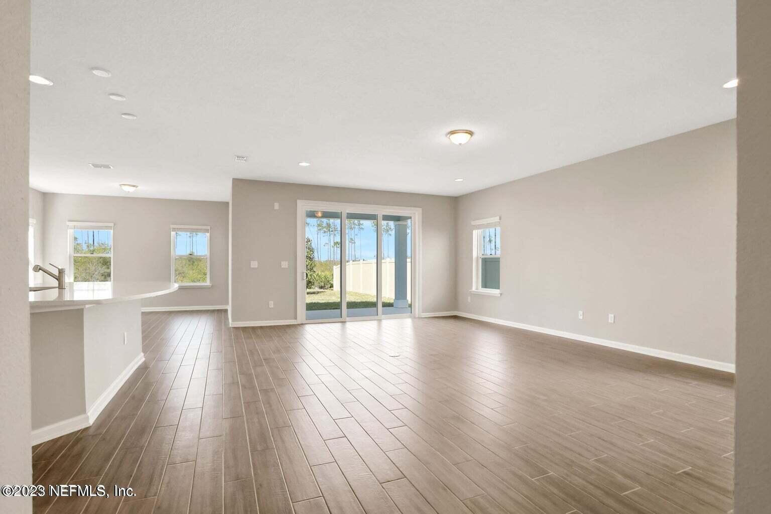 65 Torres Trace Street St. Augustine, FL 32095 - Photo 2 of 32 a view of an empty room with wooden floor and a window